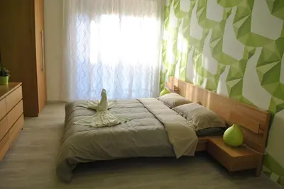 a bedroom with a large bed with a window and a curtain at Granny's House Colosseum in Rome
