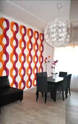 a dining room with a table and a colorful wall at Granny's House Colosseum in Rome