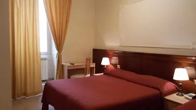 a hotel room with a red bed and a window at Rosetta in Rome