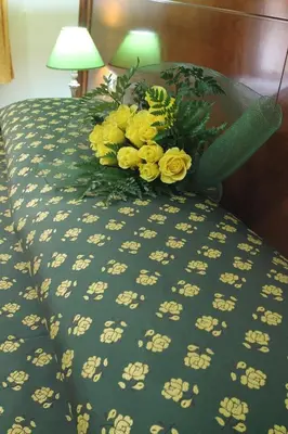 a bouquet of yellow flowers sitting on a bed at Rosetta in Rome