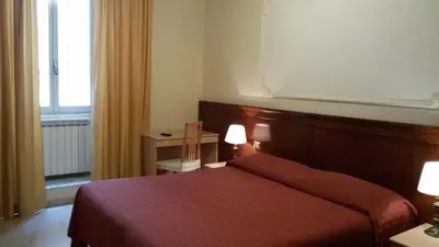 a hotel room with a red bed and a window at Rosetta in Rome