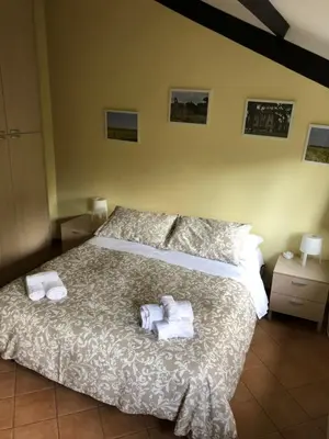 a bedroom with a bed with towels on it at Domus Santa Caterina in Rome
