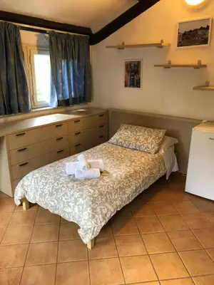 a bedroom with a bed with two towels on it at Domus Santa Caterina in Rome
