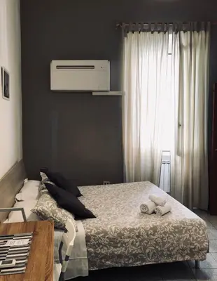 a bedroom with a bed with two stuffed animals on it at Domus Santa Caterina in Rome