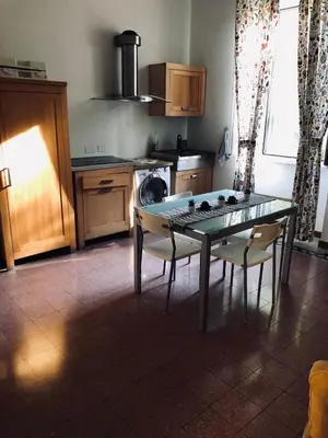 a kitchen with a table and chairs and a stove at Domus Santa Caterina in Rome