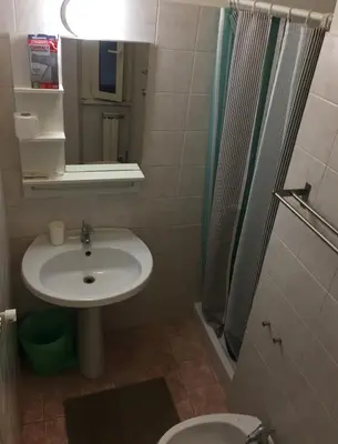 a bathroom with a toilet and a sink and a shower at Domus Santa Caterina in Rome