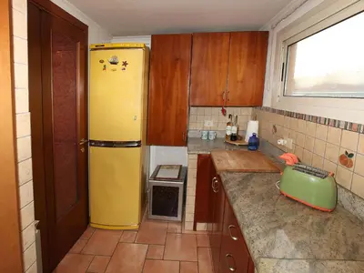 a kitchen with a yellow refrigerator and a window at Angelo Emo Terrace in Rome