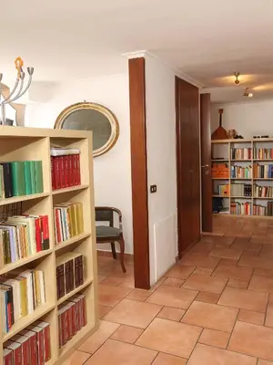 a hallway with book shelves filled with books at Angelo Emo Terrace in Rome