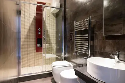a bathroom with a toilet and a sink and a shower at Residenza Edoardo I in Rome