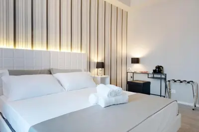 a bedroom with a white bed with towels on it at Residenza Edoardo I in Rome