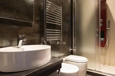 a bathroom with a sink and a toilet at Residenza Edoardo I in Rome