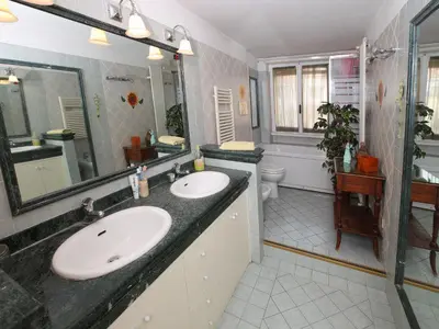 a bathroom with two sinks and a large mirror at Angelo Emo Home in Rome
