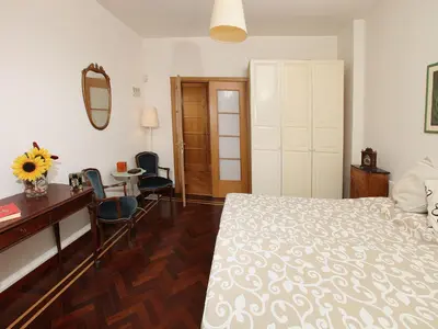 a bedroom with a bed and a desk and a mirror at Angelo Emo Home in Rome