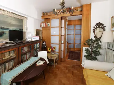 a living room with a couch and a tv at Angelo Emo Home in Rome