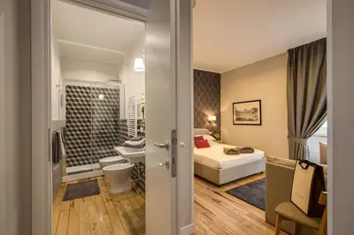 a hotel room with a bed and a bathroom at The Club Navona in Rome