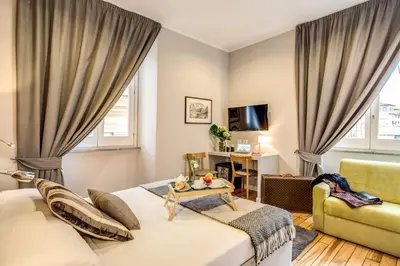 a living room with a bed and a couch at The Club Navona in Rome