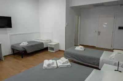 a room with two beds with towels on the floor at Hotel Bella Vita in Rome