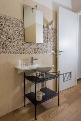 a bathroom with a sink and a mirror at Hotel Bella Vita in Rome