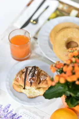 a plate with a pastry and a glass of orange juice at Hotel Bella Vita in Rome