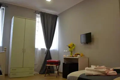 a bedroom with a bed and a tv and a window at Hotel Bella Vita in Rome
