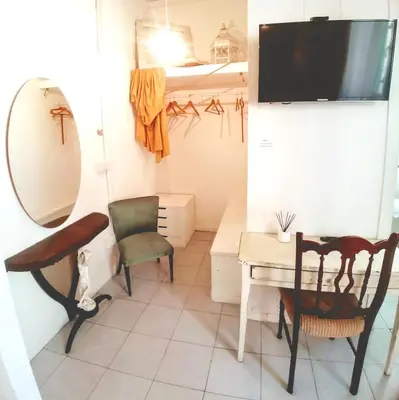 a room with a desk and a mirror and a chair at B&B Next Stop in Rome