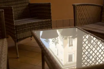 a glass table with a reflection of a building at Villa Matissa in Rome