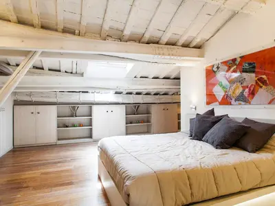 a bedroom with a large bed in a loft at Spanish Steps Luxury Penthouse in Rome