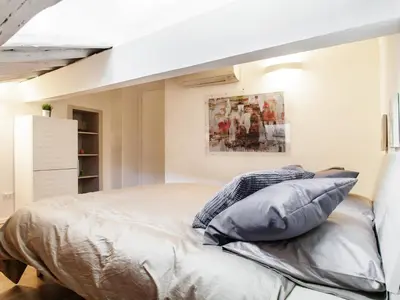 a bedroom with a bed with pillows on it at Spanish Steps Luxury Penthouse in Rome