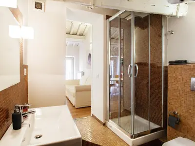 a bathroom with a shower and a sink at Spanish Steps Luxury Penthouse in Rome