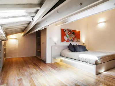 a bedroom with a bed in a loft at Spanish Steps Luxury Penthouse in Rome