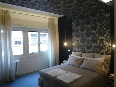a bedroom with a large bed and a window at Alma Mater B&B in Rome
