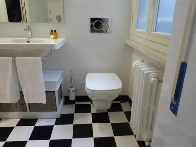 a bathroom with a white toilet and a sink at Alma Mater B&B in Rome