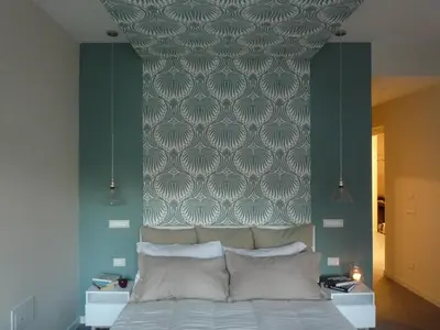 a bedroom with a bed with a headboard and a wall at Alma Mater B&B in Rome