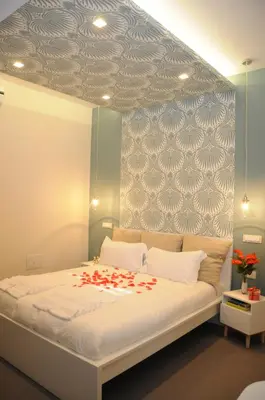 a bedroom with a bed with red flowers on it at Alma Mater B&B in Rome