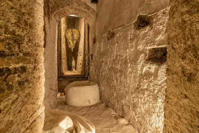 a stone bathroom with a sink and a window at Ingrami Suites and Spa in Rome