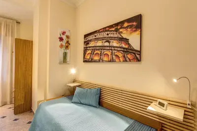 a bedroom with a bed and a picture on the wall at Residenza Amoroma in Rome