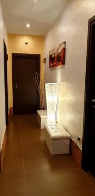 a hallway with a door and a lamp on the wall at Jadore Monic in Rome