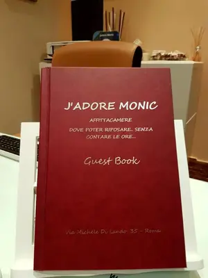 a red book sitting on top of a table at Jadore Monic in Rome