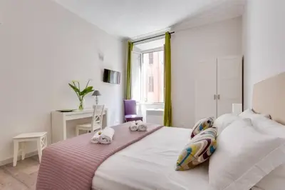 a bedroom with a bed with two stuffed animals on it at B&B Gallia's Rooms in Rome