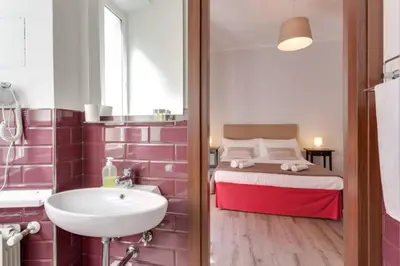 a bathroom with a sink and a bed in a room at B&B Gallia's Rooms in Rome