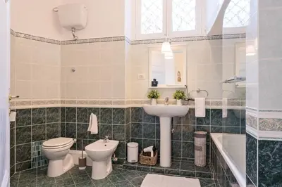 a bathroom with a toilet and a sink and a tub at TownHouse by the Spanish Steps in Rome