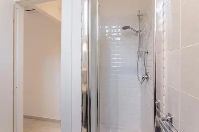 a shower with a glass door in a bathroom at TownHouse by the Spanish Steps in Rome