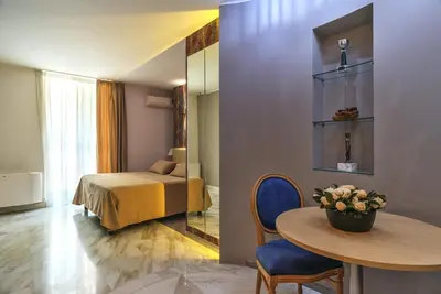 a room with a table and a bed and a bedroom at Etruria Relais in Rome