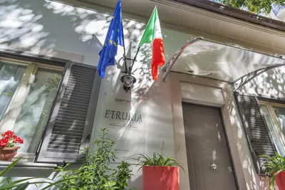 a group of flags on the side of a building at Etruria Relais in Rome