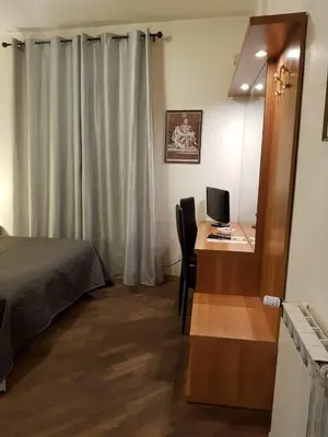 a bedroom with a bed and a desk with a computer at Domus Julia Trevi - Spagna in Rome