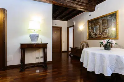 a dining room with a table with a vase on it at Domus Julia Trevi - Spagna in Rome