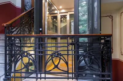 a staircase with a black iron railing and a glass door at Casa Tommasina in Rome