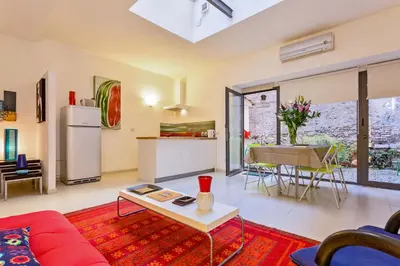 a living room with a red couch and a table at Rome as you feel - Selci Apartment in Rome