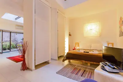 a bedroom with a bed and a tv in a room at Rome as you feel - Selci Apartment in Rome