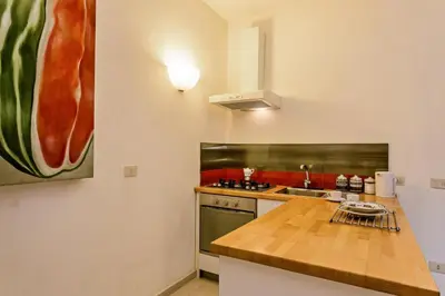 a kitchen with a stove and a counter top at Rome as you feel - Selci Apartment in Rome